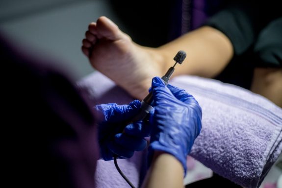 a person using a pedicure tool